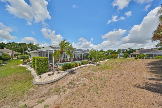 view of yard with a pool and a lanai