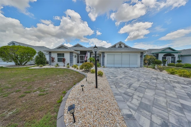 ranch-style home featuring a garage and a front lawn