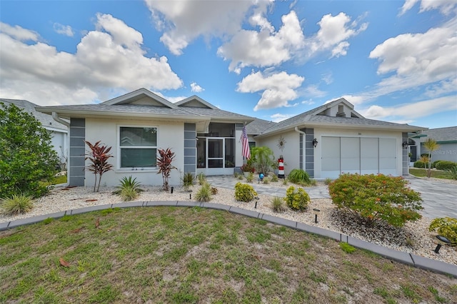 single story home featuring a front yard and a garage