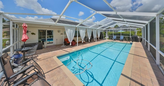 view of pool with a lanai and a patio