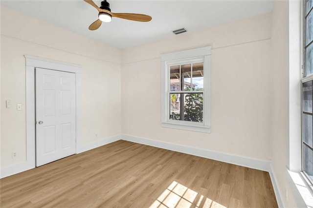 spare room featuring light hardwood / wood-style floors and ceiling fan