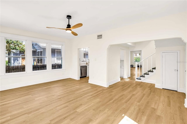 unfurnished living room featuring ceiling fan, sink, and light hardwood / wood-style floors