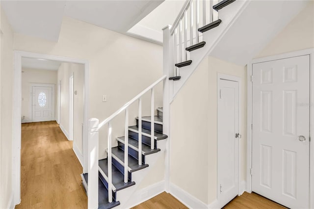 stairs with light hardwood / wood-style floors