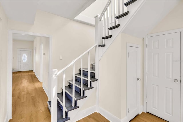 staircase featuring wood-type flooring