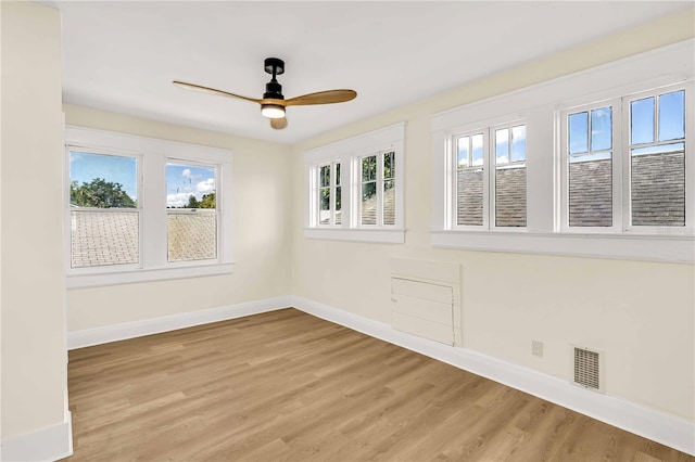 spare room featuring light hardwood / wood-style flooring and ceiling fan