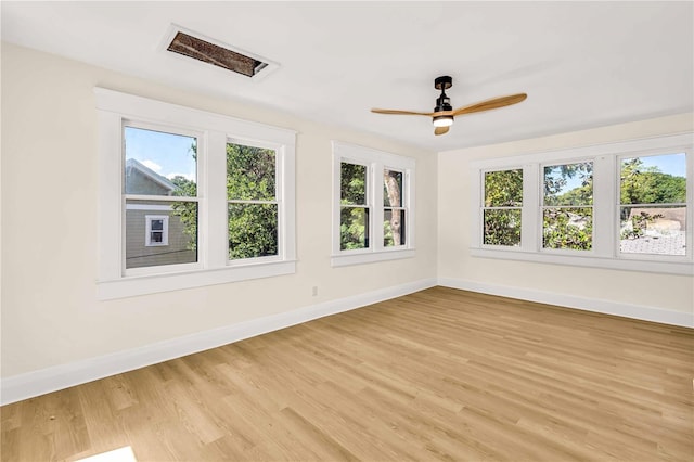 spare room featuring ceiling fan and light hardwood / wood-style flooring