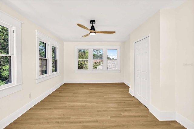 unfurnished sunroom with ceiling fan