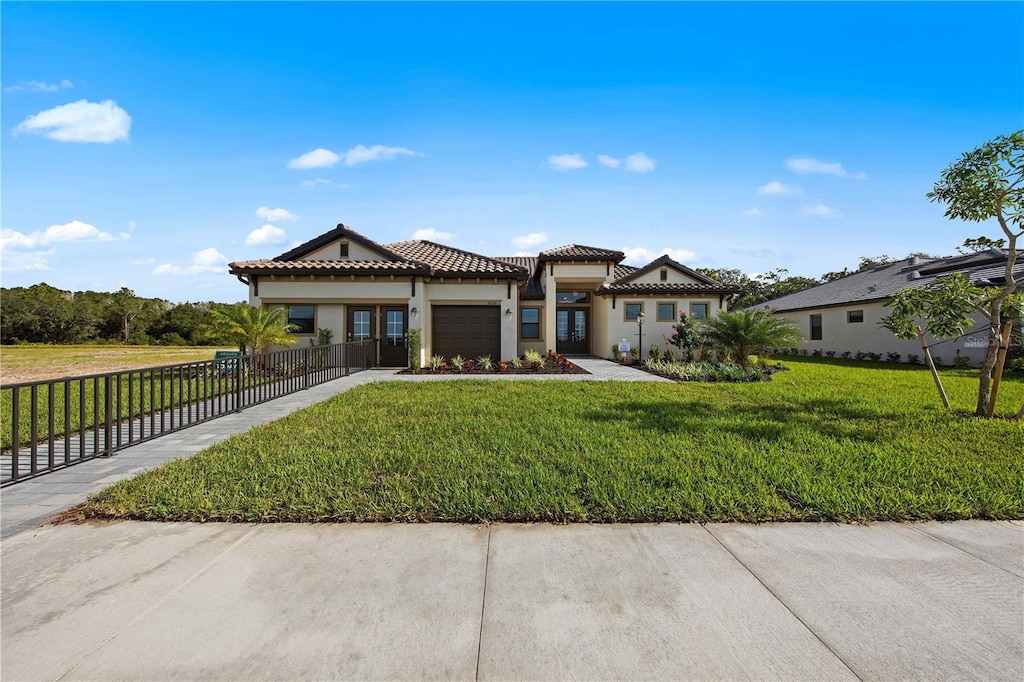 view of front of property featuring a front lawn and a garage