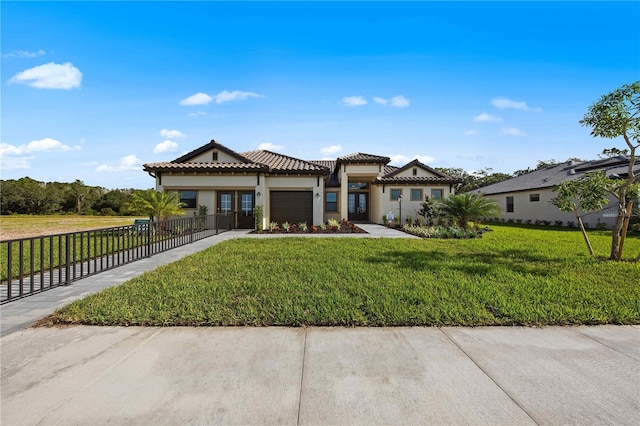 view of front of property featuring a front lawn and a garage