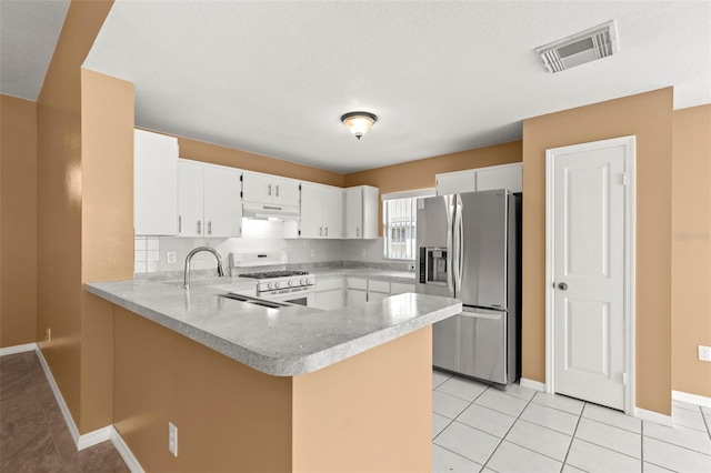 kitchen featuring white cabinetry, kitchen peninsula, stainless steel fridge with ice dispenser, and white range with gas stovetop