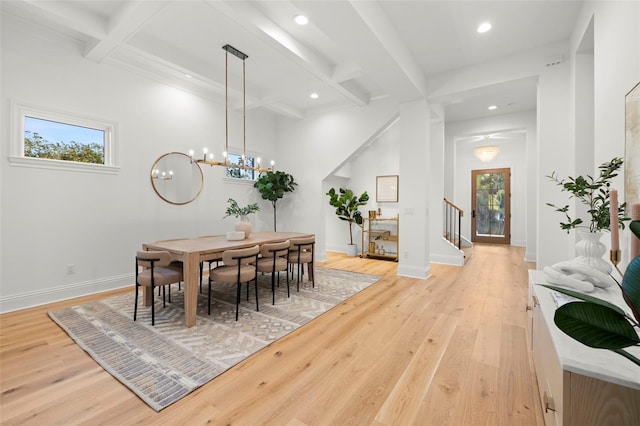 dining room with coffered ceiling, a notable chandelier, light hardwood / wood-style flooring, and beamed ceiling