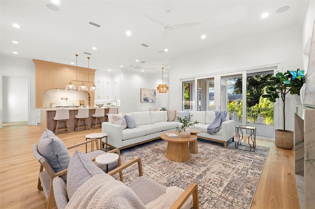 living room featuring light hardwood / wood-style flooring and ceiling fan