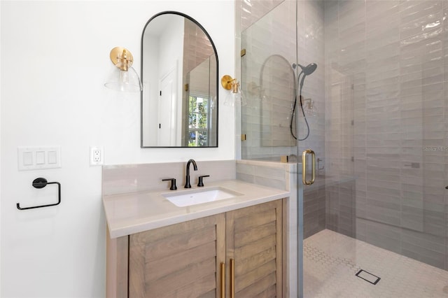 bathroom featuring vanity and a shower with door