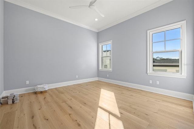 empty room with crown molding, ceiling fan, and light hardwood / wood-style floors