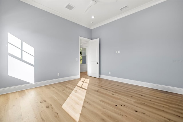 spare room with ceiling fan, ornamental molding, and light hardwood / wood-style floors