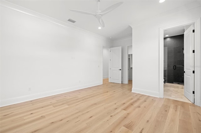 unfurnished bedroom with ceiling fan, ensuite bath, ornamental molding, and light hardwood / wood-style flooring