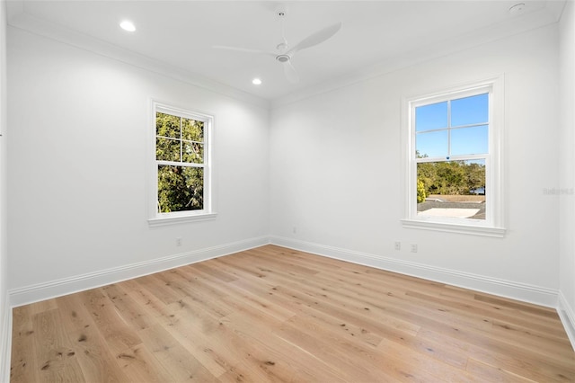 empty room featuring crown molding, ceiling fan, and light hardwood / wood-style flooring