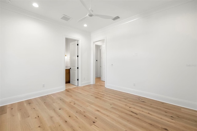 spare room featuring ornamental molding, ceiling fan, and light hardwood / wood-style flooring