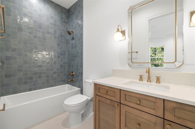 full bathroom featuring tiled shower / bath, vanity, and toilet