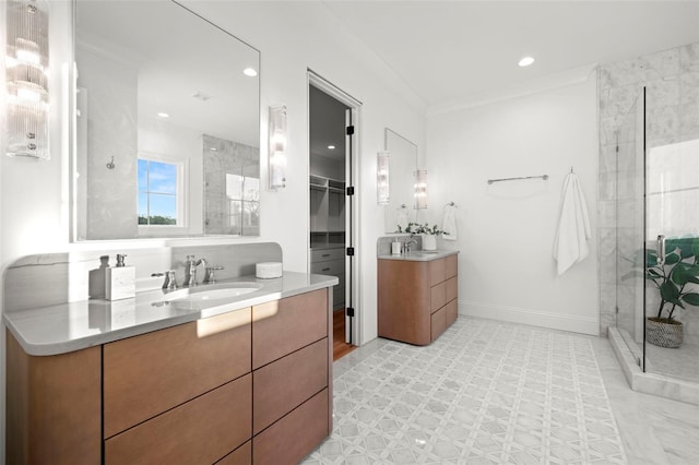 bathroom with ornamental molding, vanity, and a shower with door