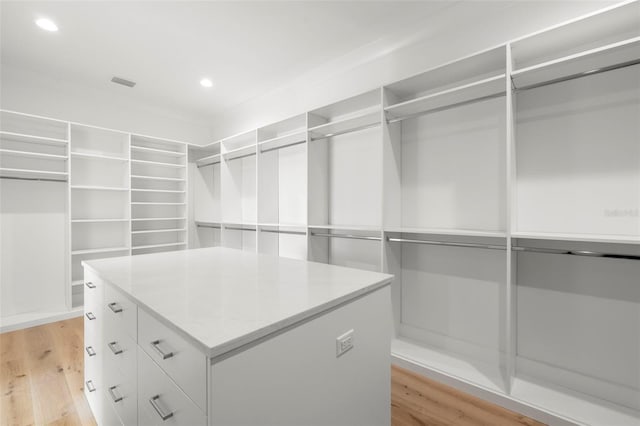 walk in closet featuring light hardwood / wood-style flooring