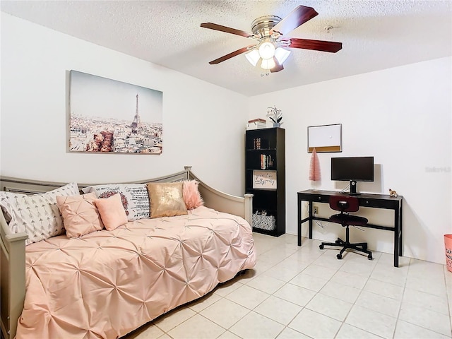 tiled bedroom featuring ceiling fan and a textured ceiling