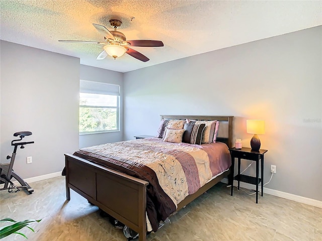 bedroom featuring a textured ceiling and ceiling fan