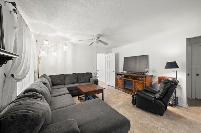 living room featuring ceiling fan and a textured ceiling