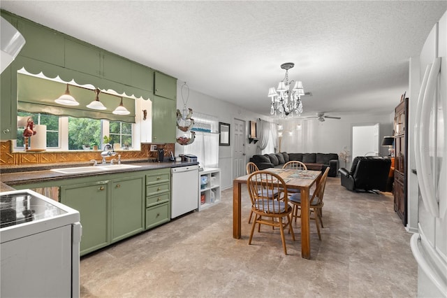 kitchen featuring sink, a textured ceiling, white appliances, ceiling fan with notable chandelier, and green cabinetry