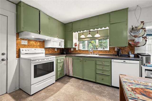 kitchen with decorative backsplash, white appliances, green cabinetry, and sink