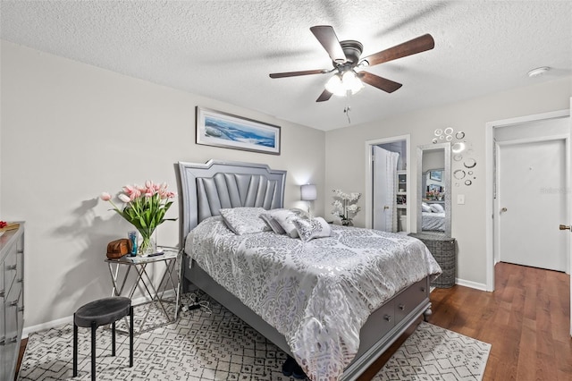 bedroom featuring ceiling fan, a textured ceiling, and hardwood / wood-style flooring