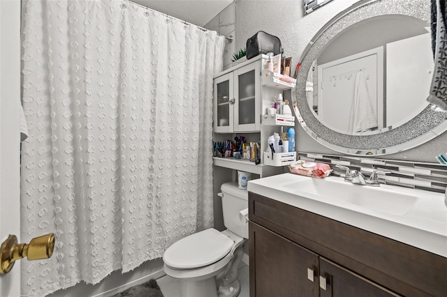 bathroom featuring decorative backsplash, vanity, and toilet