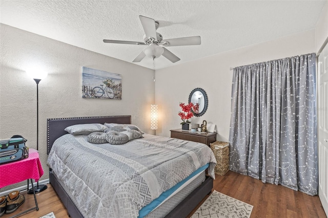 bedroom featuring hardwood / wood-style floors, ceiling fan, and a textured ceiling