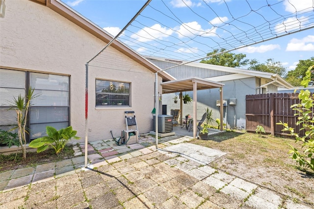 back of property featuring central AC unit and a patio area