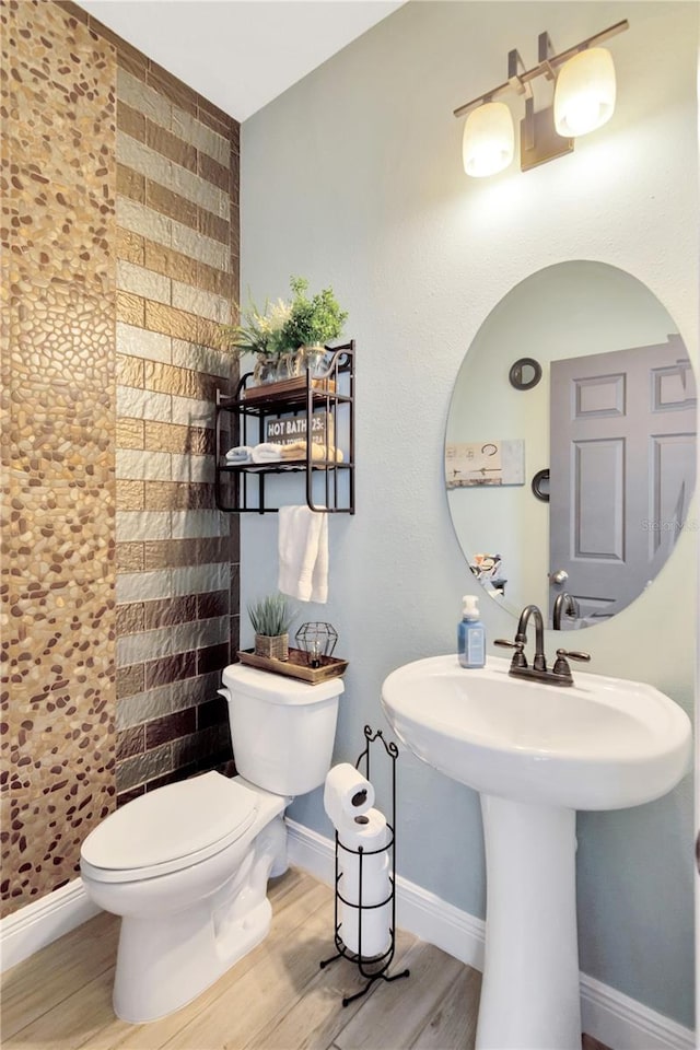 bathroom with wood-type flooring and toilet