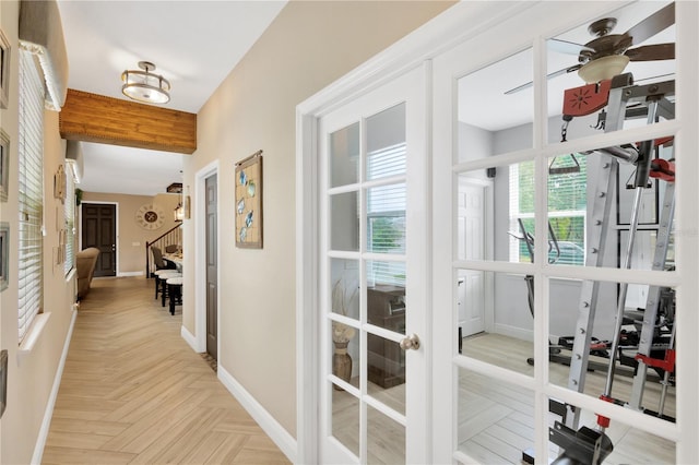 hallway with light parquet floors and a healthy amount of sunlight