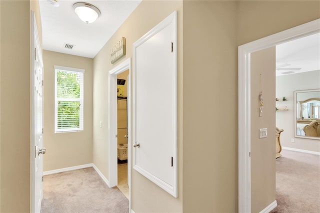 hallway featuring light carpet