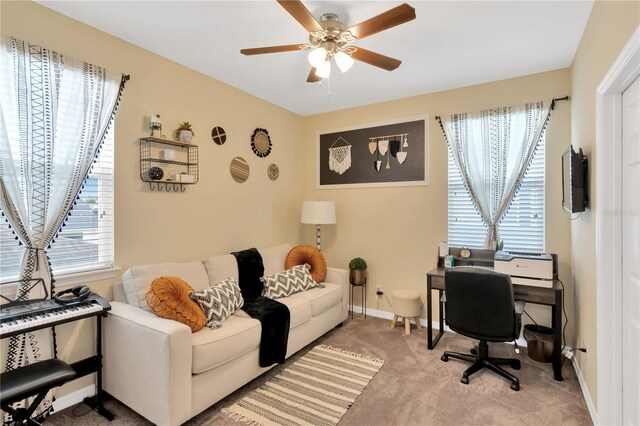 carpeted office featuring ceiling fan