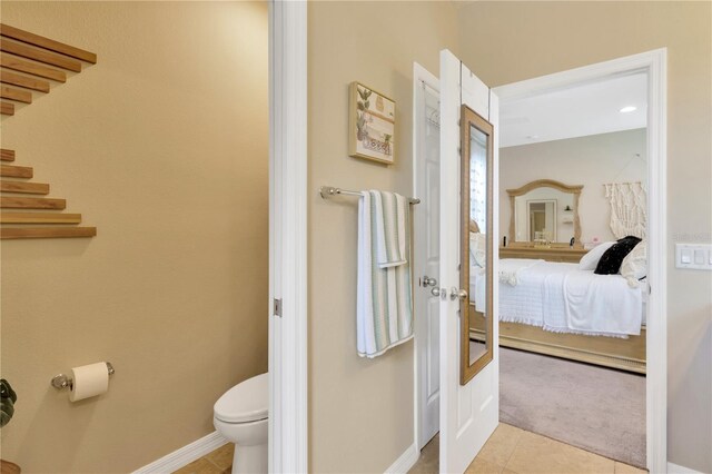 bathroom with tile patterned flooring and toilet