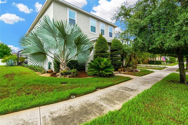 view of side of home featuring a yard