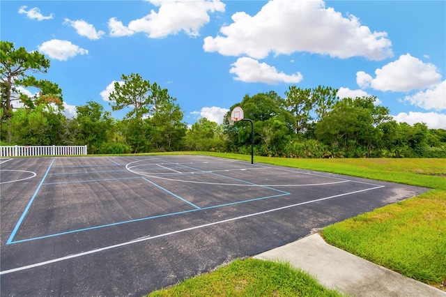 view of sport court featuring a lawn