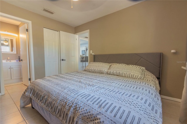 tiled bedroom featuring connected bathroom