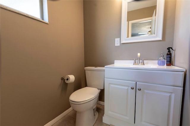 bathroom with tile patterned flooring, vanity, and toilet