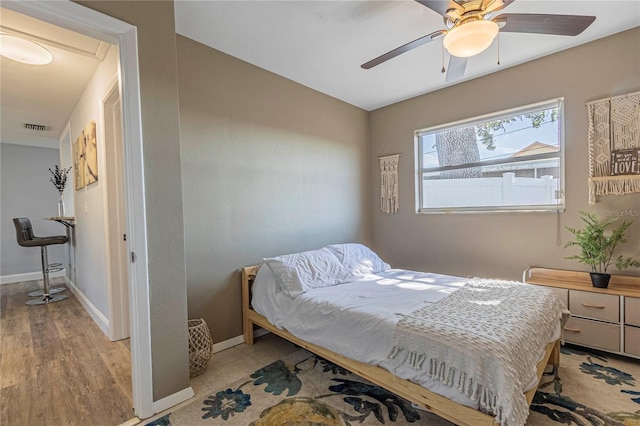 bedroom with ceiling fan and light hardwood / wood-style flooring