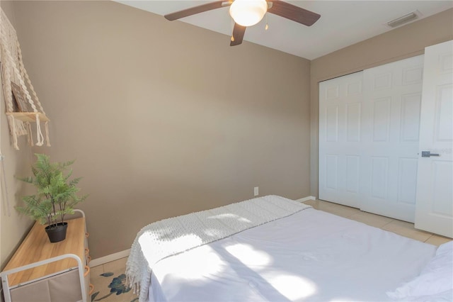 tiled bedroom with a closet and ceiling fan