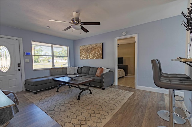 living room featuring light wood-type flooring and ceiling fan