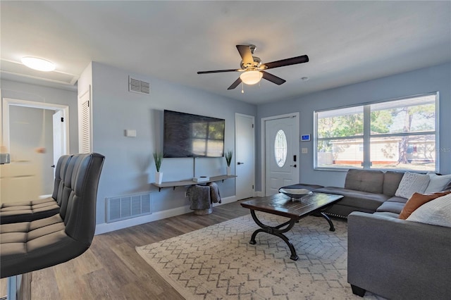 living room with wood-type flooring and ceiling fan