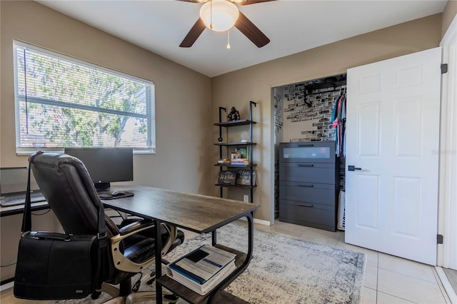 office area with ceiling fan, plenty of natural light, and light tile patterned floors