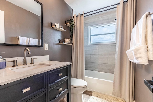 full bathroom with vanity, toilet, shower / bathtub combination with curtain, and hardwood / wood-style flooring