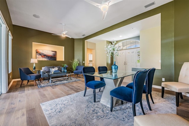 dining space with ceiling fan and light hardwood / wood-style floors